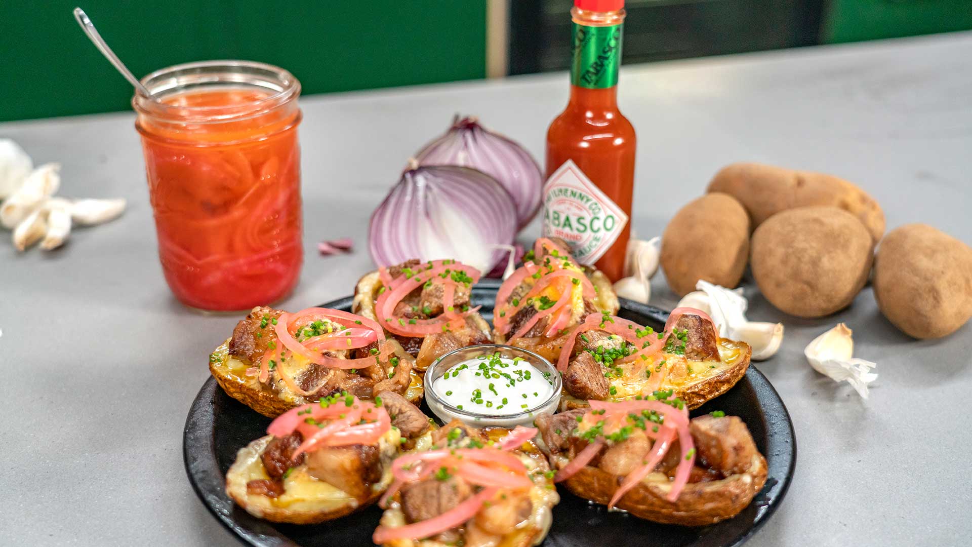 Steak & Cheese Potato Skins with Roasted Garlic and TABASCO® Sauce Compound Butter